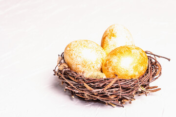 Golden Easter eggs in a wicker nest