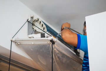 Plastic collecting waste water while cleaning air conditioner indoors