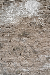 Half-finished cement plastered brick wall. Texture background wallpaper. Vertical shot.
