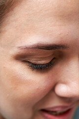 Fototapeta na wymiar Close up of a beautiful female eye and a processed eyebrow