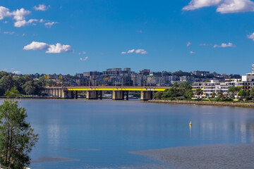 Fototapeta na wymiar Rhodes bridge and apartment buildings on Parramatta river Sydney NSW Australia