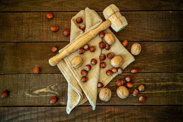 nuts and towel on wooden background