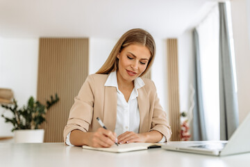 Female using her notebook, writing.