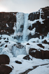 Fototapeta na wymiar Waterfall with clear blue water in winter Iceland