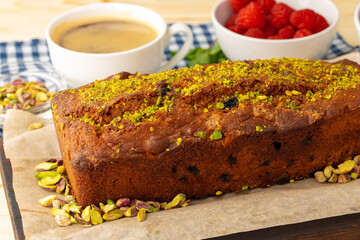 Sponge cake with pistachio on wooden board