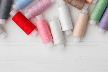 Close up of colored thread coils, thread spools background