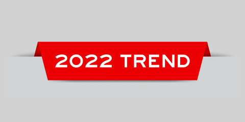 Red color inserted label with word 2022 trend on gray background