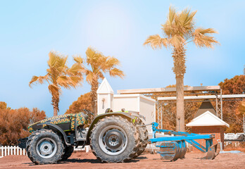 TURKEY, ANTALYA - MARCH 26, 2021: Tractor for the preparation and leveling of sand by the sea for holidaymakers tourists.