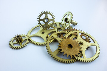Brass gears from old mechanisms on white isolate