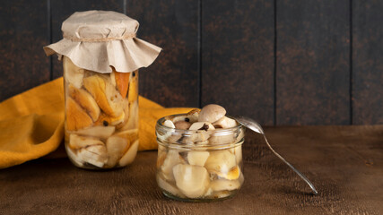 Mushrooms Boletus Edulis. Marinated pickled edible mushrooms boletus edulis in glass jars with...