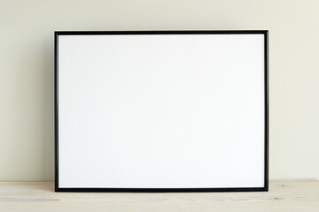 Simple minimal black horizontal frame mockup on light wood shelf, frame mock up in living room for design presentation.
