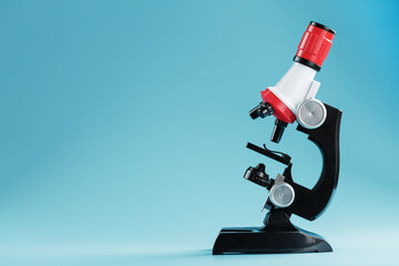 Laboratory microscope on a blue background for scientific research on a blue background.