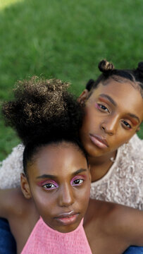 Family Portrait of Sisters Sitting in Grassy Backyard