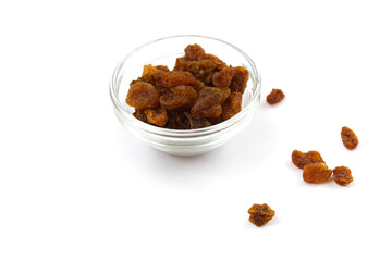 handful of dry raisins in glass bowl on white isolated background
