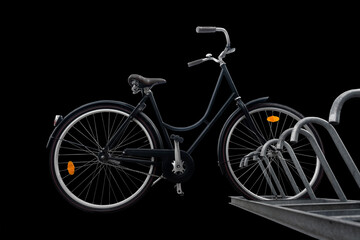 Fototapeta na wymiar Low angle view of black traditional parked bike on dark background