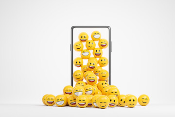 Yellow happy emoji smile falling from smartphone screen over white background.