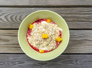 Organic oats in bowl with fruits and yoghurt