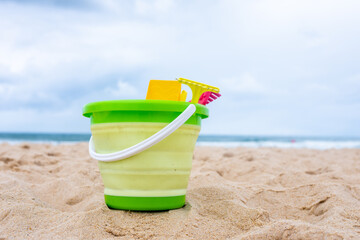 Beach toys on the sand with towel