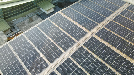 Fototapeta premium Aerial view of a solar panel on building roof top. Part of reduce reuse and restore, Renewable energy concept 