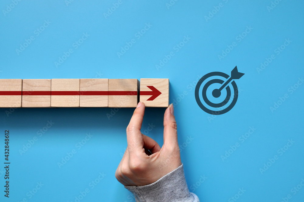 Poster the red arrow moves towards the target. a symbol of purposeful movement towards the goal