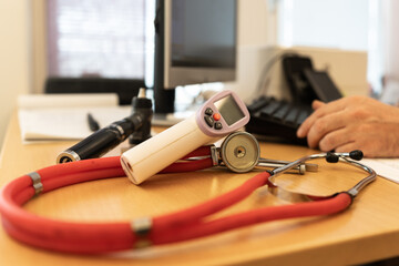 Doctor's table in the doctor's office. Special tools for diagnostics: phonendoscope, tuning fork, hammer and others. Family doctor and medical assistance. Health protection.