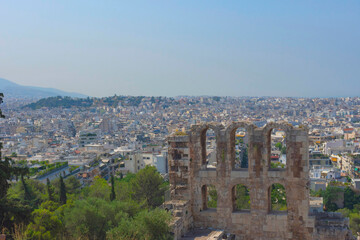 Fototapeta na wymiar Ancient Odeon of Herodes Atticus Roman theater under the ruins of Acropolis, with view over the city of Athens, Greece, in summer sunny day