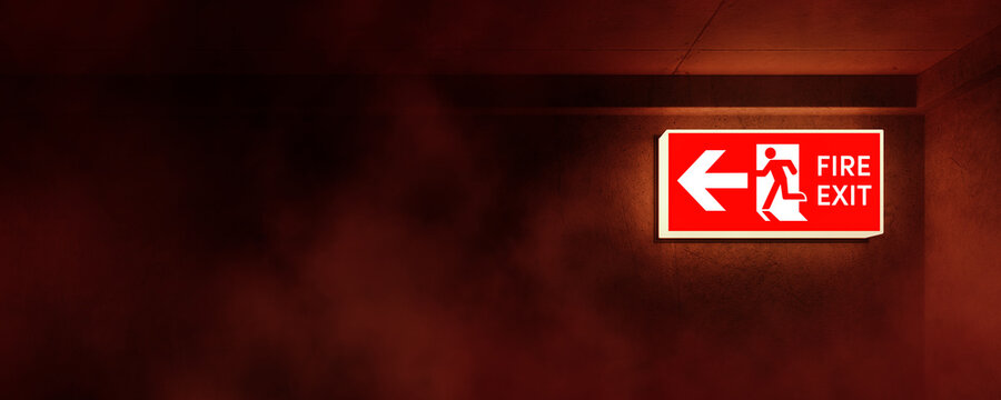 Emergency concept. Illuminated emergency exit sign in hallway or office with smoke rising. Corridor point way out. 3D rendering.