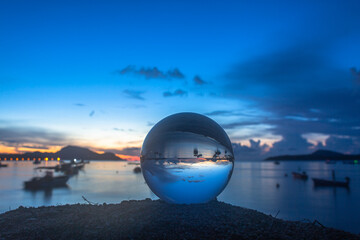 Fototapeta na wymiar view of the sea and sky inside crystal ball. The natural view of the sea and sky are unconventional and beautiful. .A image for a unique and creative travel idea.