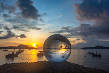 view of the sea and sky inside crystal ball. The natural view of the sea and sky are unconventional and beautiful. .A image for a unique and creative travel idea.
