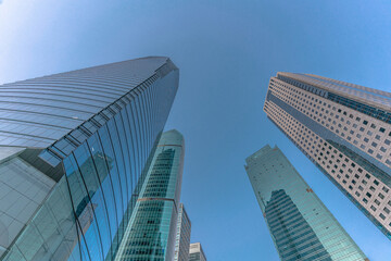 Fototapeta na wymiar Low angle view of modern skyscraper with blue sky in Shanghai, China.