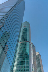 Low angle view of modern skyscraper with blue sky in Shanghai, China.