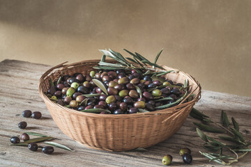 Fresh olives in basket on wooden table copy space.	