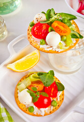 Round crispbread toast with greens and vegetables. Healthy food concept.