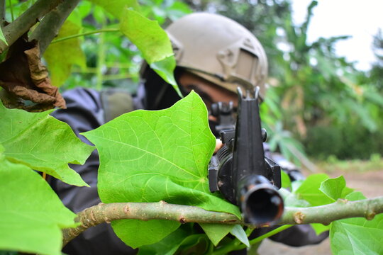 soldiers behind the leaves