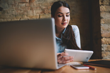 Thoughtful woman with tablet watching video