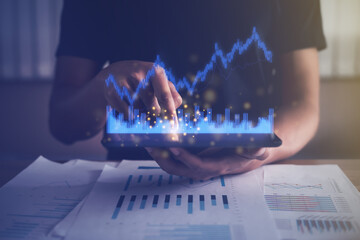 Businessman analyzing financial, fund, account data from growing investments. Virtual graph...
