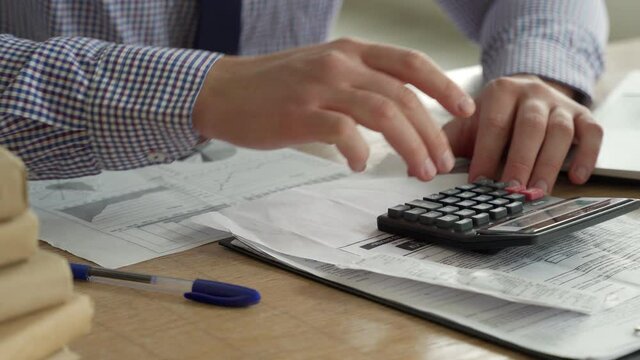 Concept of tax deduction planning. Businessman who calculates the business balance on a calculator is preparing a tax cut.