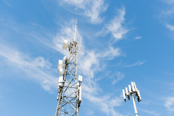 Radio, communication and cell towers on blue sky background