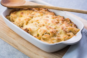 Tetrazzini -chicken pasta casserole in a baking dish with ingredients at background, american cuisine, view from above
