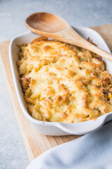 Tetrazzini -chicken pasta casserole in a baking dish with ingredients at background, american cuisine, view from above