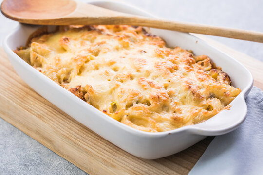 Tetrazzini -chicken pasta casserole in a baking dish with ingredients at background, american cuisine, view from above