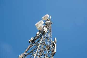 Radio, communication and cell tower on blue sky background