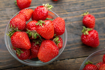 Ripe red strawberries on wooden table