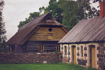 Fototapeta na wymiar Wooden and stone houses. Rural landscape. The open air Museum in Tallinn. Retro toned.