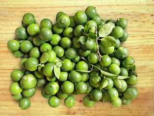 Fresh green lemon a pile of lemons on the wooden table