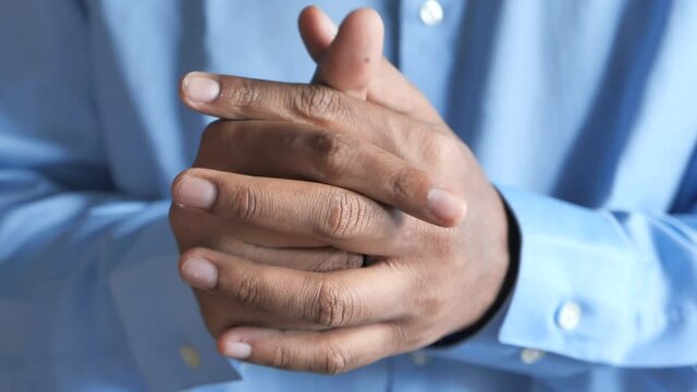 a nervous young man hand 