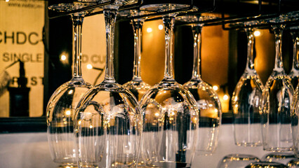 Wine glasses hung upside down.