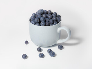 Blueberries in a large cup bowl on a white background