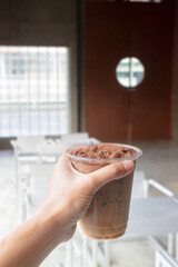 Hand on iced chocolate cocoa