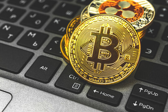 Bitcoin and other crypto currency coins new virtual money concept background, laptop with coins on it, business and financial photo with close-up of golden bitcoin